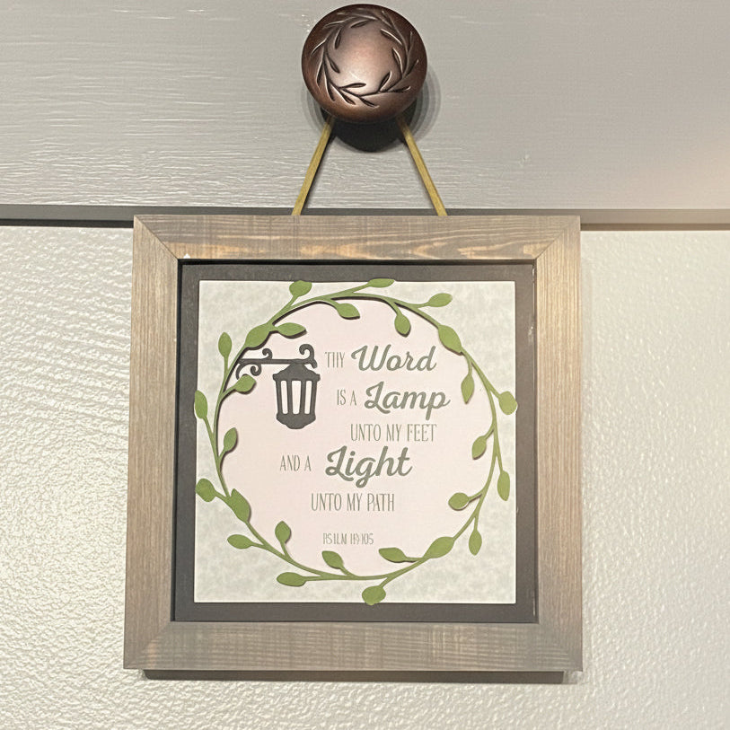 Framed print with decorative text and design on a wall.