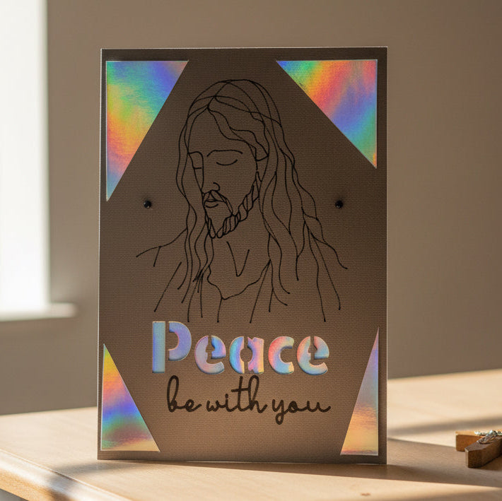 Card with a line drawing of a person and 'Peace be with you' text on a brown background with rainbow accents.
