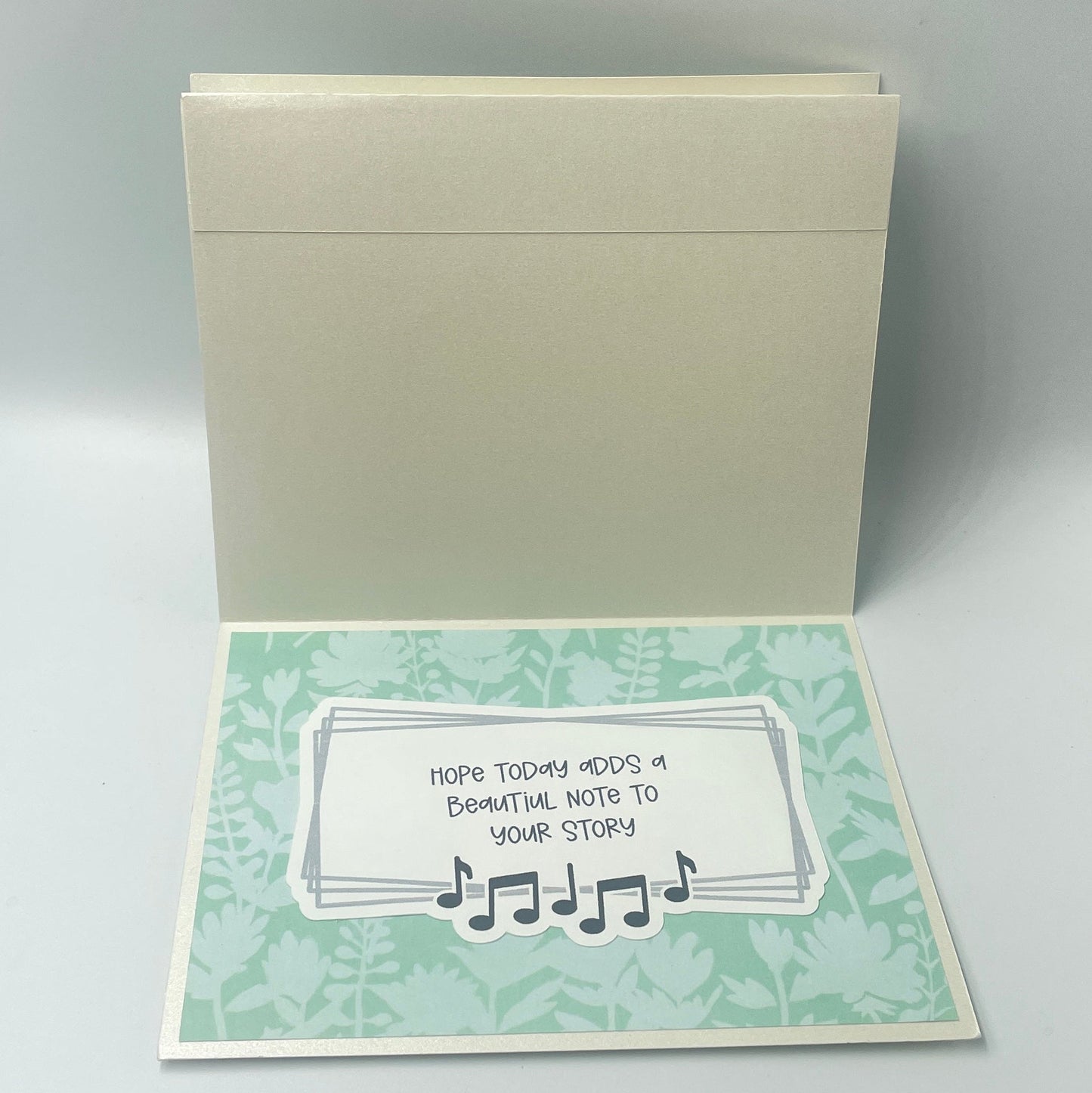 Open card with text and decorative elements on a light gray background