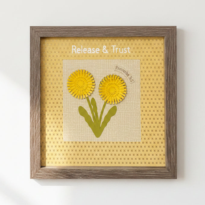 Framed artwork with yellow flowers and 'Release & Trust' text on a textured background.