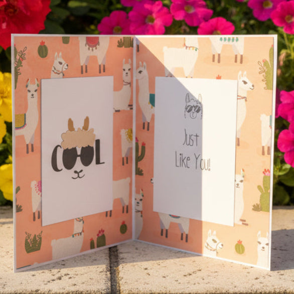 Card with llama design in front of colorful flowers