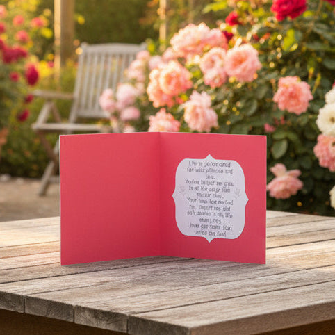 Red card with a white interior featuring a heartfelt message on a light gray background