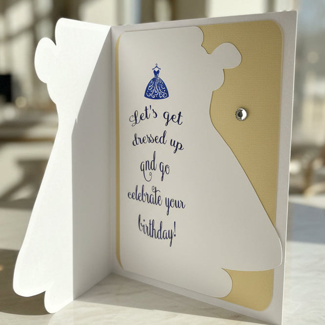 Greeting card with a dress silhouette and text on a white surface