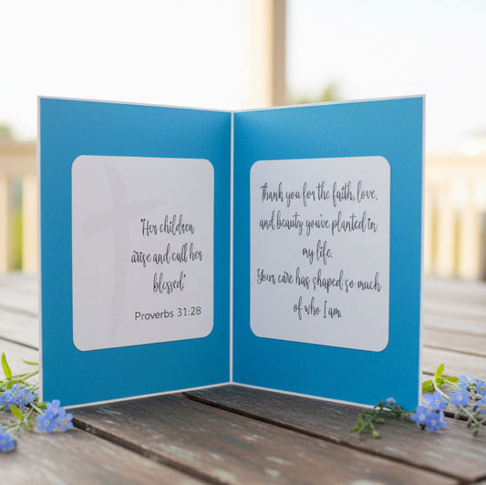 Blue card with text on a wooden surface outdoors