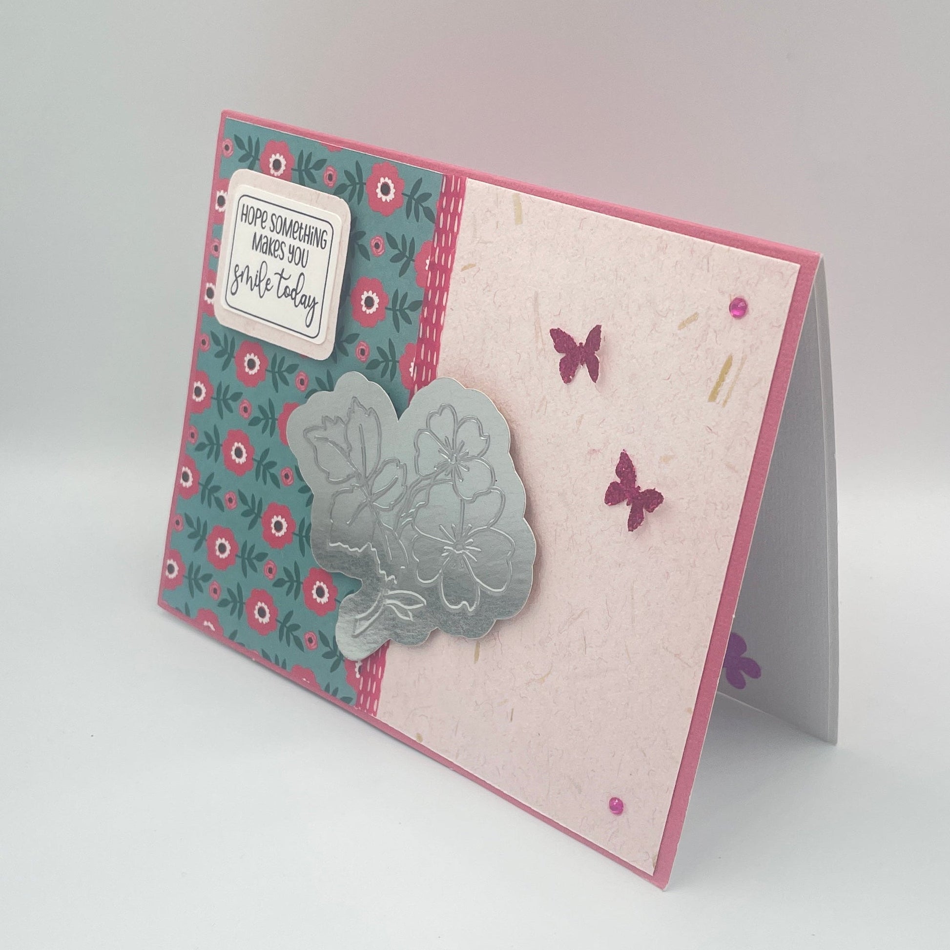 Greeting card with floral patterns and butterfly designs on a light gray background