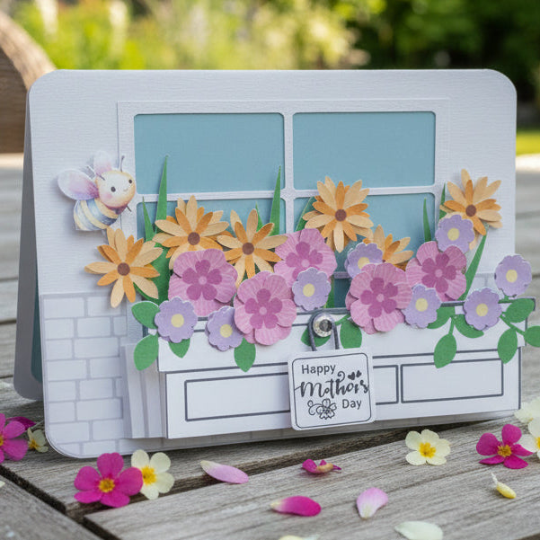 Card with floral design and 'Happy Mother's Day' text on a wooden surface with flowers around.