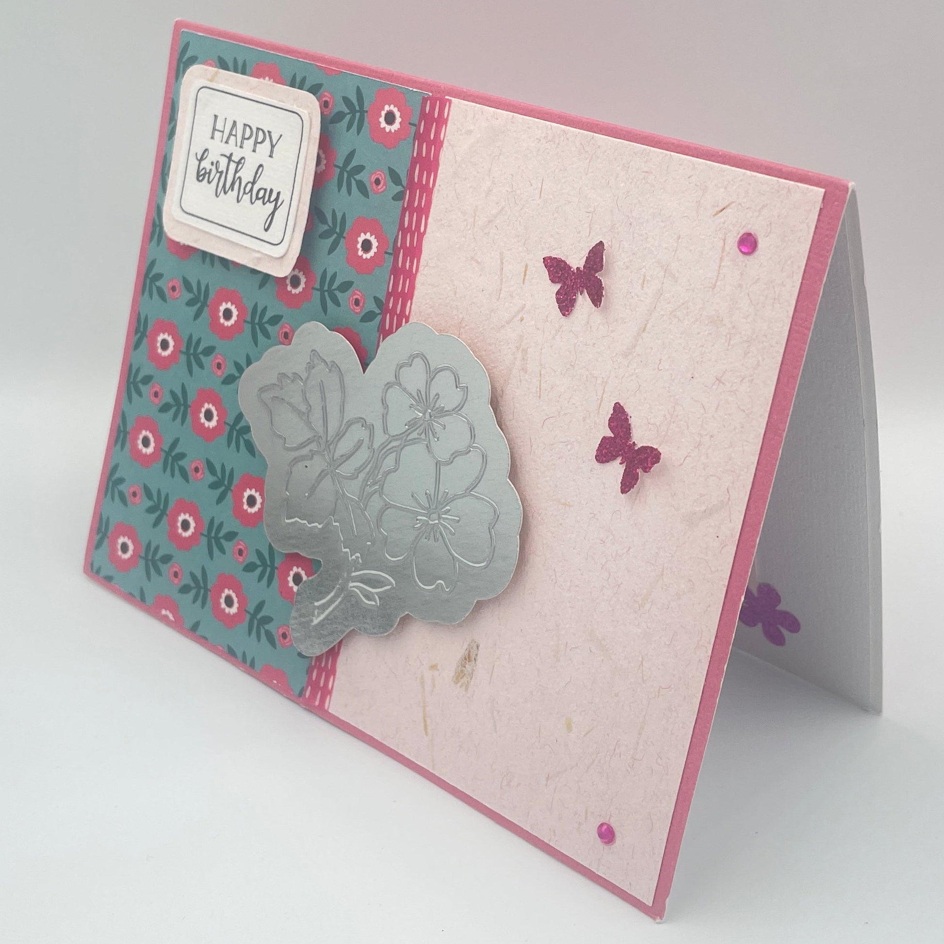 Decorative card with floral design and butterfly elements on a white background