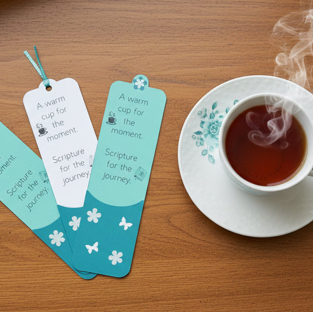 Tea cup with saucer and bookmarks on a wooden surface