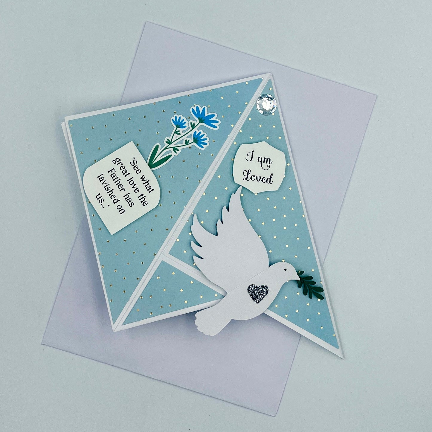 Greeting card with dove and floral design on a light gray background