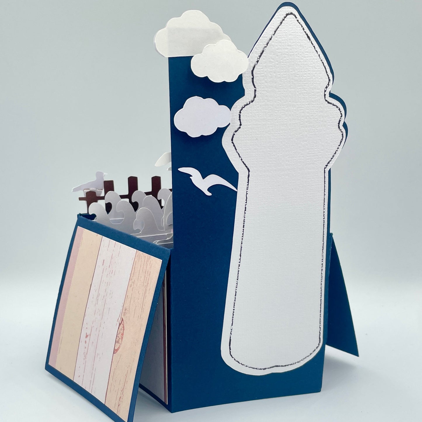 Back of lighthouse box card on a gray background