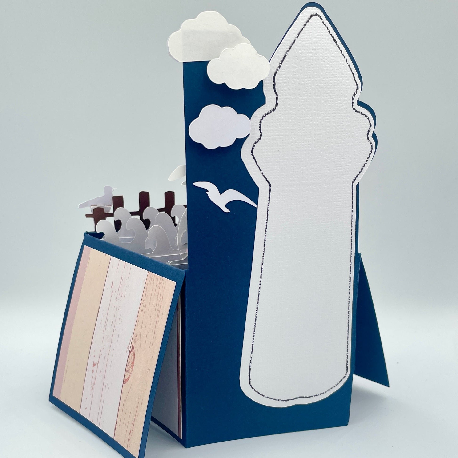 Back of lighthouse box card on a gray background