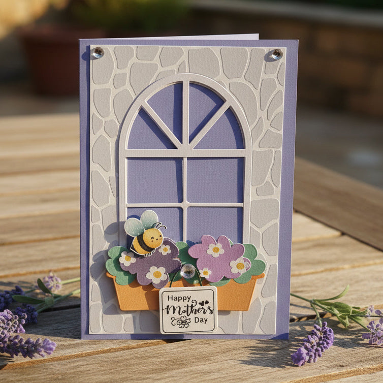Greeting card with floral design and 'Happy Mother's Day' text on a wooden surface with flowers.