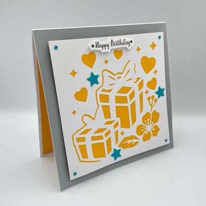 Greeting card with yellow gift boxes, hearts, and flowers on a gray background