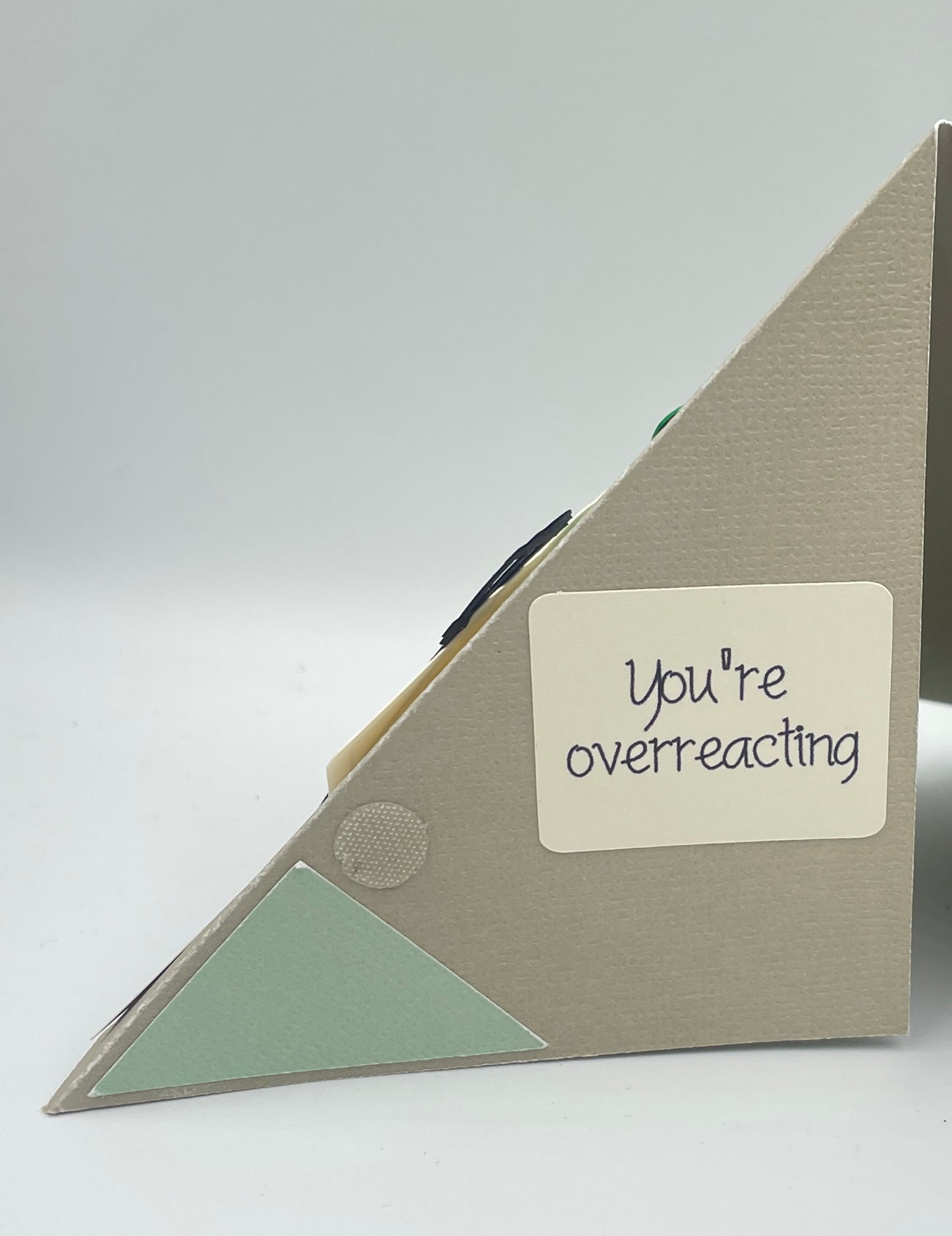 Triangular card with 'You're overreacting' text on a white background