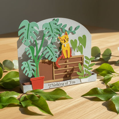 Card with a cat and plants design and 'Thinking of You' text on a white background