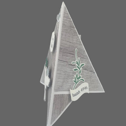 Decorative triangle with a plant design and 'Isaiah 9:16' text on a gray background