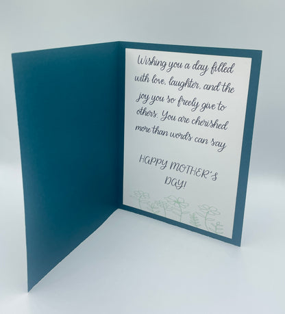 Mother's Day card with a blue interior and white exterior with text.