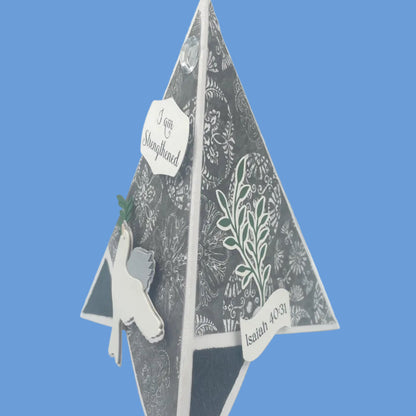 Decorative paper cutout with geometric design on a blue background