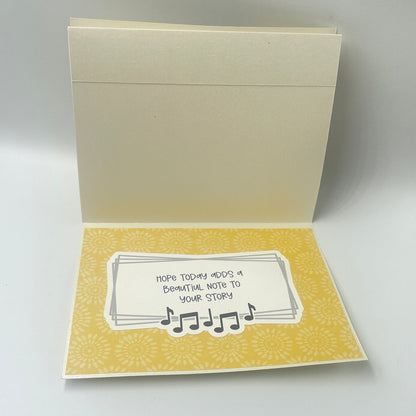Open book with a card inside on a gray background