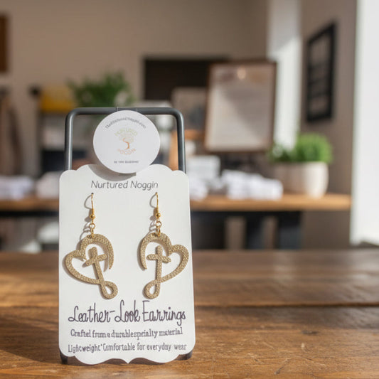 Card with heart-shaped earrings on a wooden surface