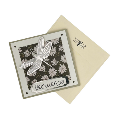 Front view of dragonfly card positioned with envelope