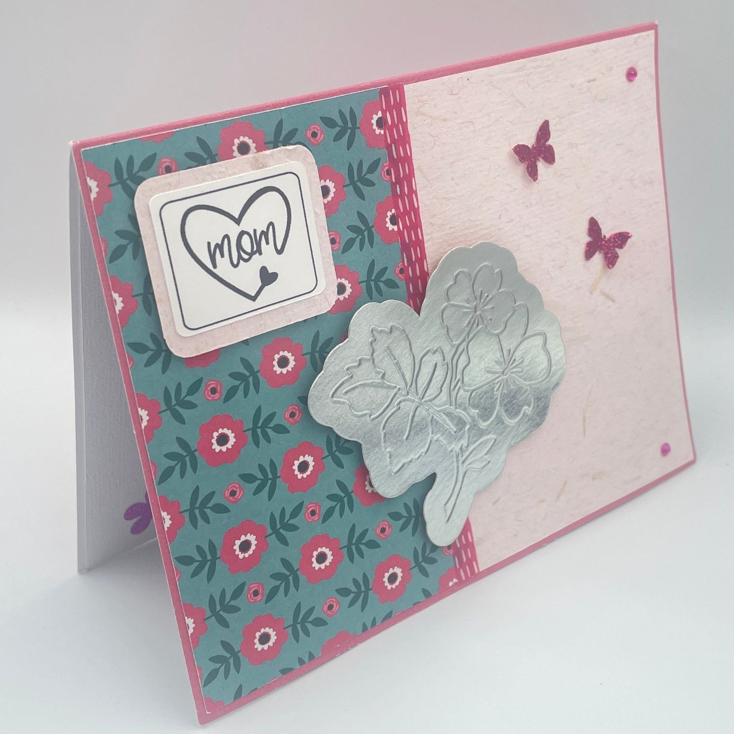 Decorative card with floral design and butterfly on a white background