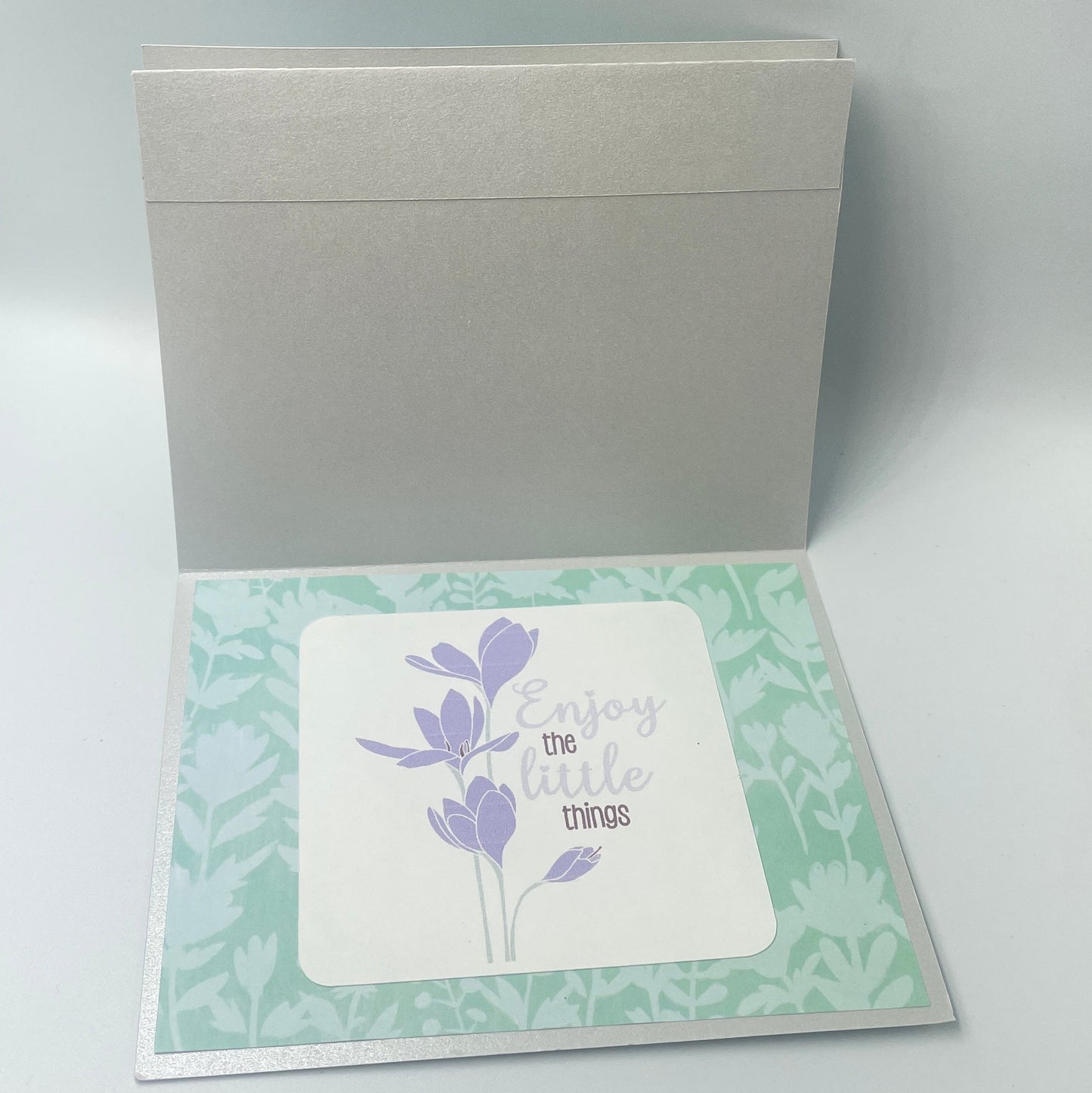 Greeting card with floral design on a light gray background