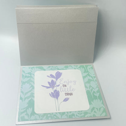 Greeting card with floral design on a light gray background
